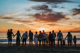 people standing on shore during golden hour by Tyler Nix courtesy of Unsplash.